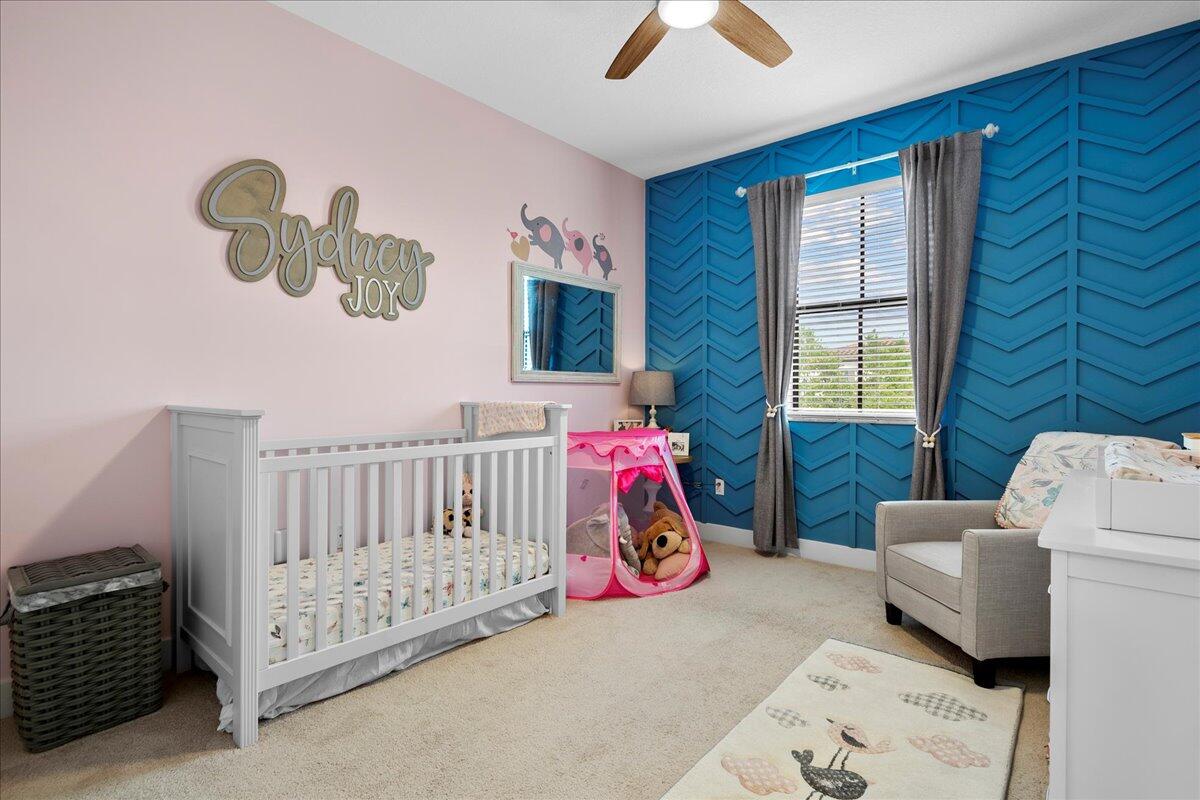 6013 Pine Tree Way Riviera Beach, FL 33410 - Photo 20 of 33 a bedroom with a bed and a window