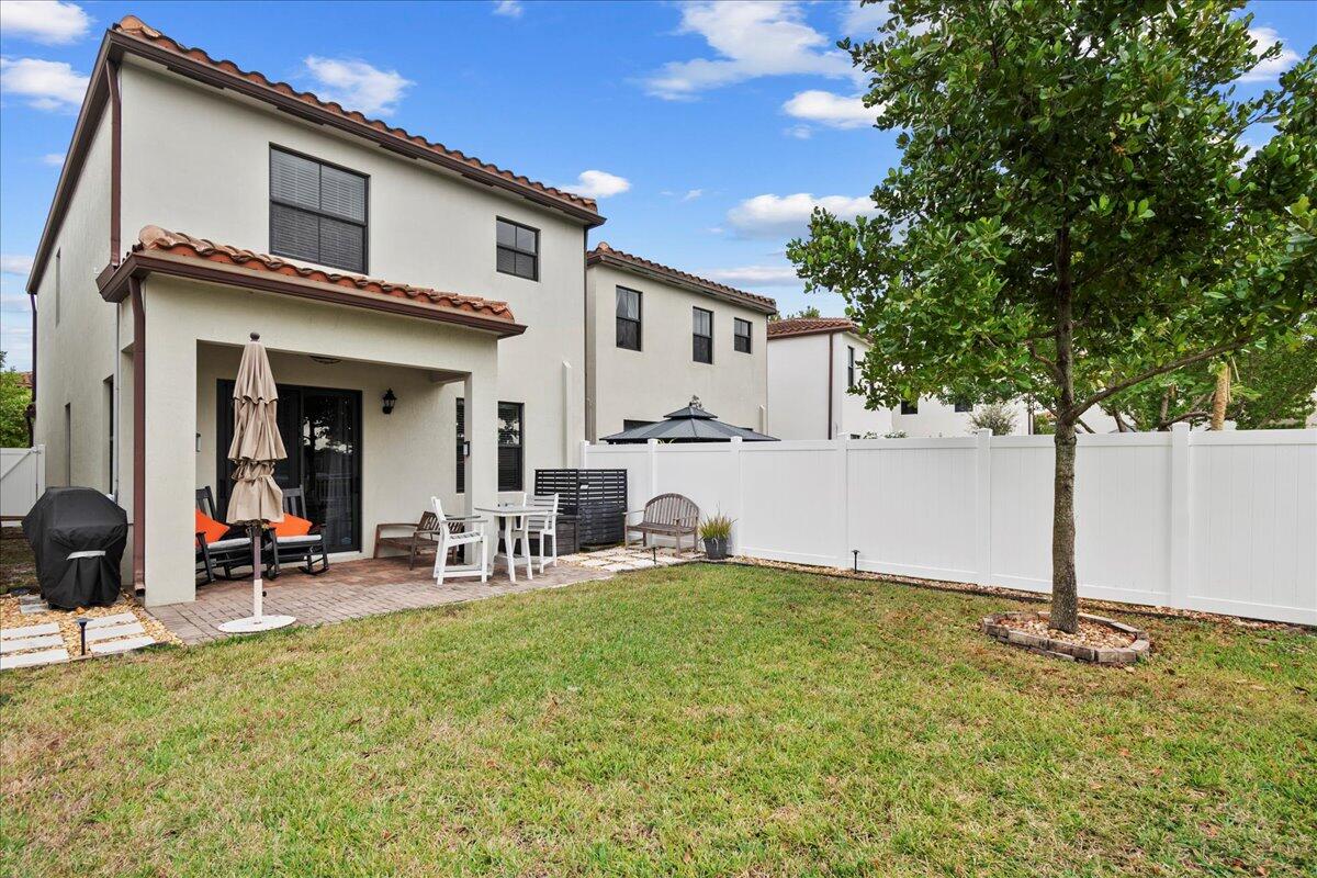 6013 Pine Tree Way Riviera Beach, FL 33410 - Photo 23 of 33 a view of a house with backyard and sitting area