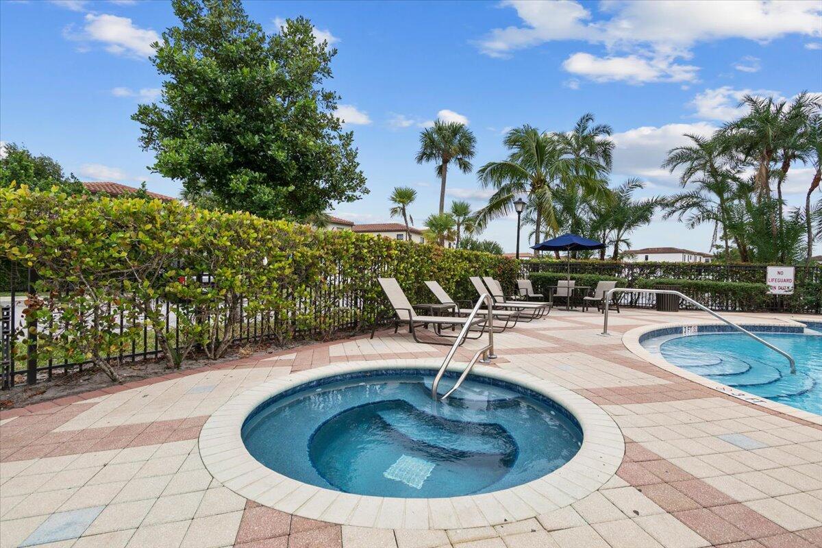 6013 Pine Tree Way Riviera Beach, FL 33410 - Photo 26 of 33 a view of a swimming pool with outdoor seating