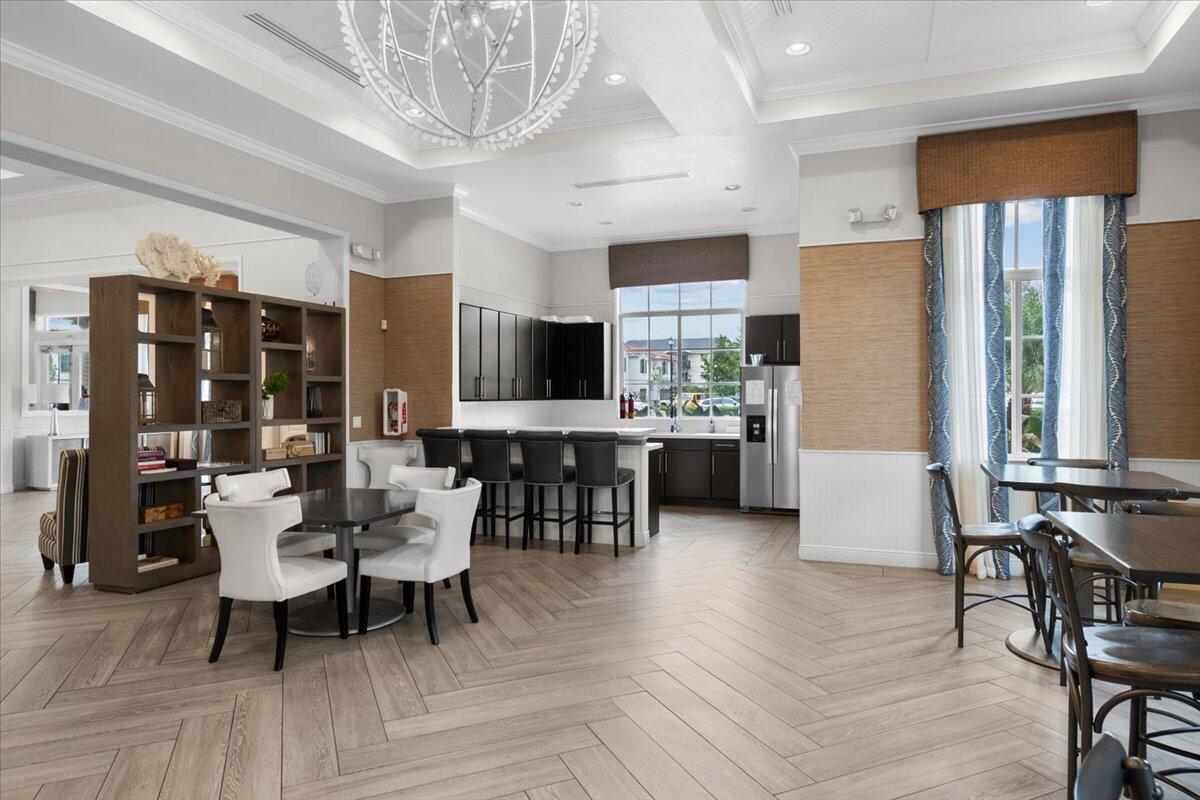 6013 Pine Tree Way Riviera Beach, FL 33410 - Photo 32 of 33 a view of a dining room with furniture window and wooden floor