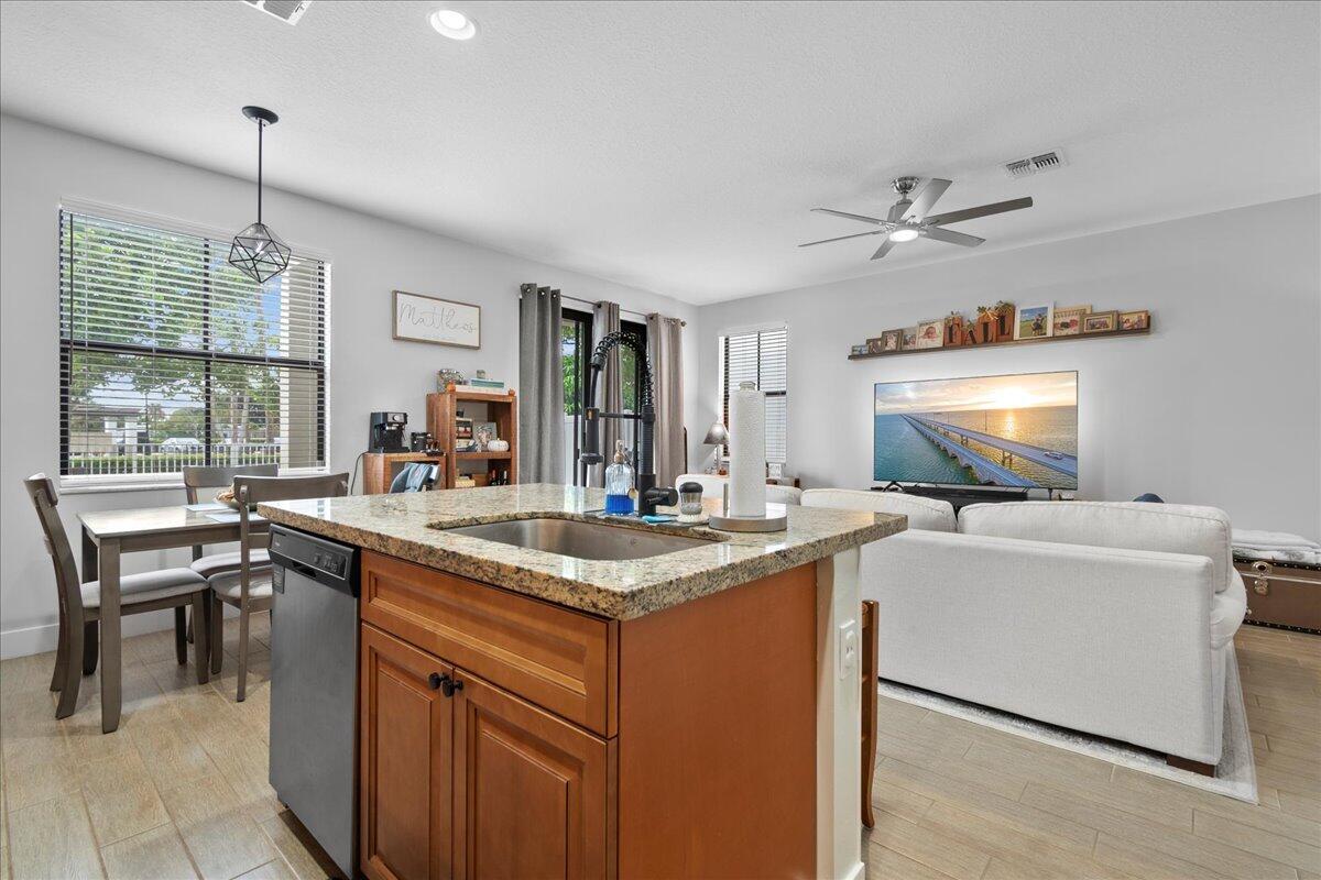 6013 Pine Tree Way Riviera Beach, FL 33410 - Photo 5 of 33 a kitchen with a stove a sink and a refrigerator