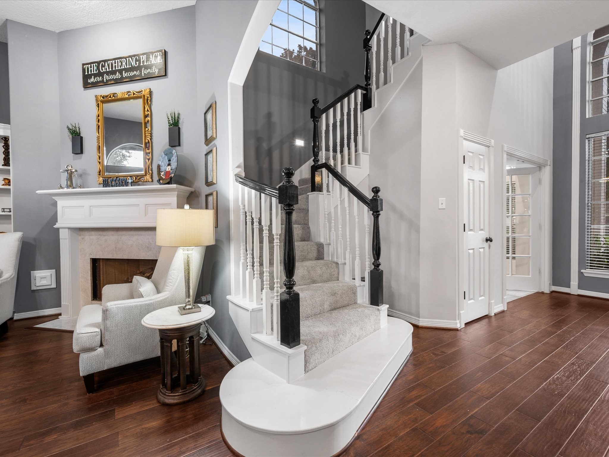 5910 Center Ct Drive Spring, TX 77379 - Photo 26 of 50 An elegant staircase with wood spindles leads to the second level, where a large window fills the space with natural light and highlights the home’s refined, updated interior.
