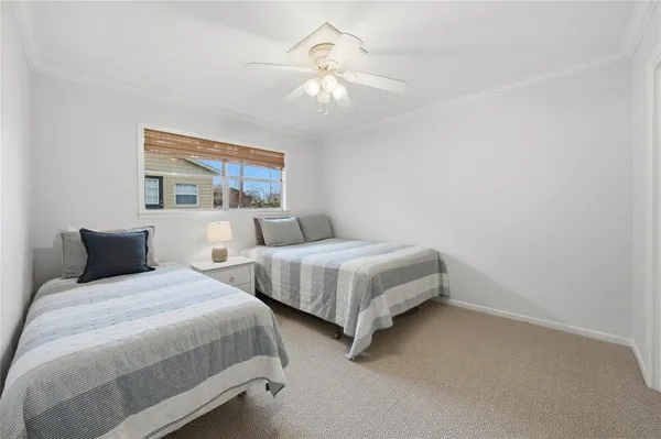 a bedroom with two beds and a chandelier