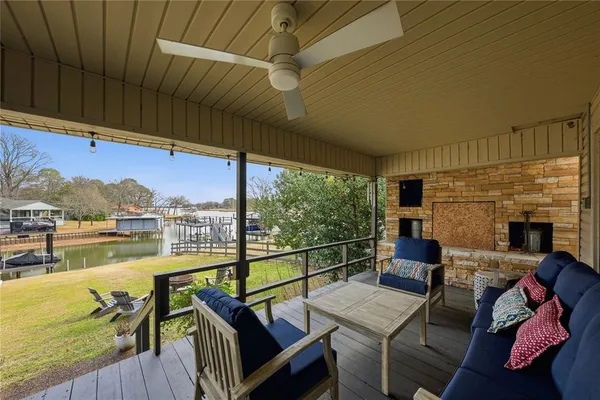 a balcony with furniture and a fireplace