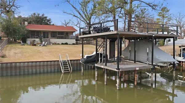 a view of a swimming pool with a table and chairs under an umbrella