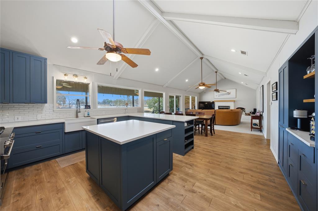 111 Ridgeoak Way Tool, TX 75143 - Photo 7 of 21 a kitchen with a stove a counter top space a sink cabinets and wooden floor