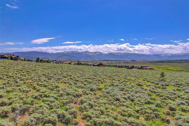 a view of mountain with sunset in background