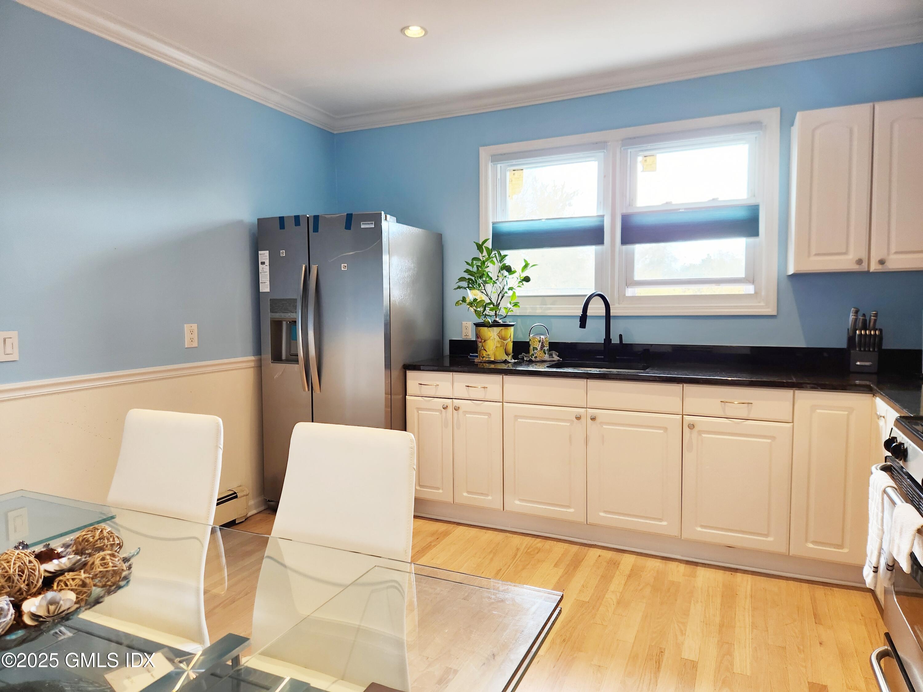 61 Aberdeen Street, Unit 3 Stamford, CT 06902 - Photo 3 of 17 a kitchen with stainless steel appliances a refrigerator sink and white cabinets