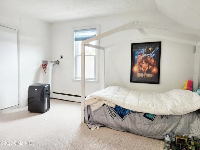 a bedroom with a bed and a window