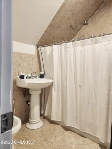 a bathroom with a sink a mirror and a shower