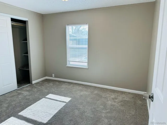 a view of kitchen with stainless steel appliances granite countertop white cabinets and refrigerator