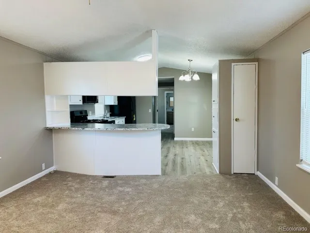a kitchen with stainless steel appliances a stove microwave and sink