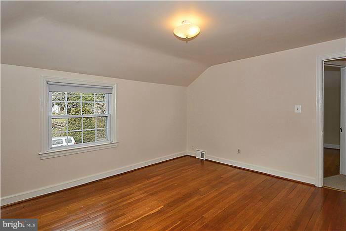 318 Whitestone Road Silver Spring, MD 20901 - Photo 14 of 28 an empty room with wooden floor and windows