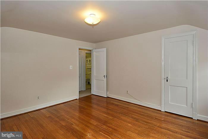 318 Whitestone Road Silver Spring, MD 20901 - Photo 15 of 28 a view of an empty room with wooden floor and a window