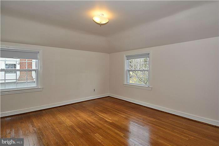 318 Whitestone Road Silver Spring, MD 20901 - Photo 16 of 28 a view of an empty room with wooden floor and a window