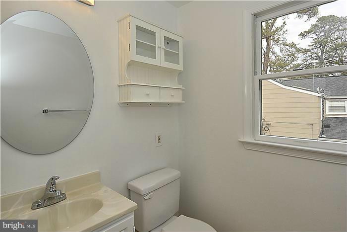 318 Whitestone Road Silver Spring, MD 20901 - Photo 17 of 28 a bathroom with a toilet sink and mirror