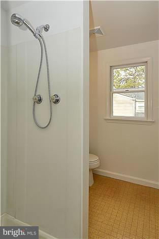 318 Whitestone Road Silver Spring, MD 20901 - Photo 18 of 28 a bathroom with a granite countertop toilet and a shower