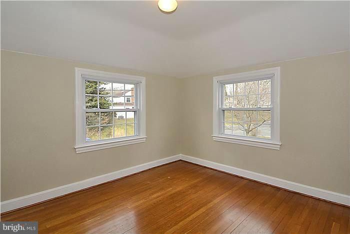 318 Whitestone Road Silver Spring, MD 20901 - Photo 19 of 28 an empty room with wooden floor and windows