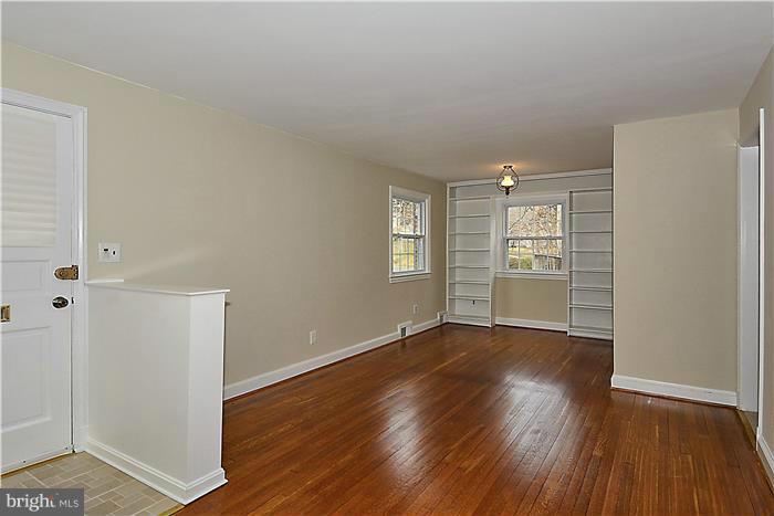318 Whitestone Road Silver Spring, MD 20901 - Photo 3 of 28 an empty room with wooden floor closet and windows