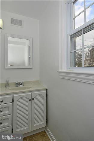 318 Whitestone Road Silver Spring, MD 20901 - Photo 24 of 28 a bathroom with a sink and a mirror