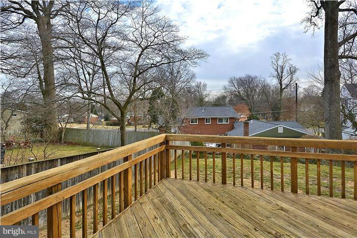 318 Whitestone Road Silver Spring, MD 20901 - Photo 27 of 28 a view of a wooden deck with trees