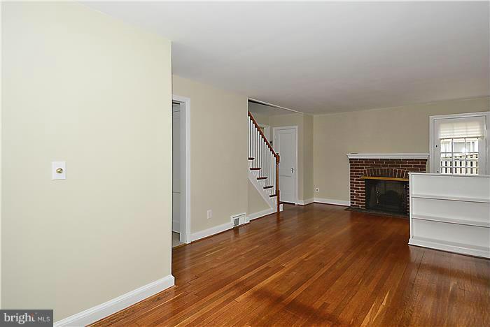 318 Whitestone Road Silver Spring, MD 20901 - Photo 5 of 28 a view of a livingroom with wooden floor and a staircase