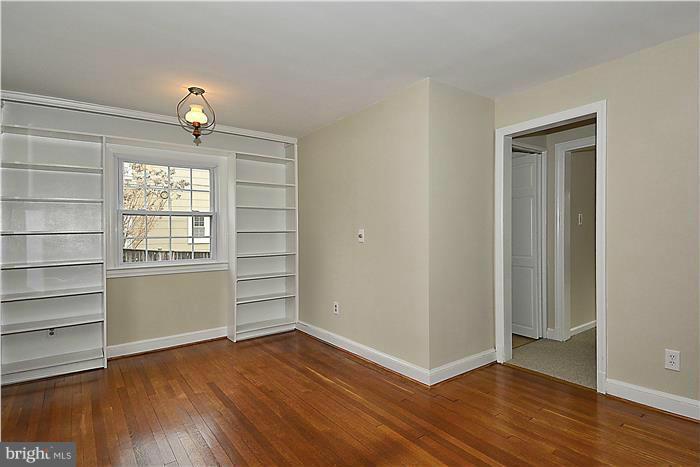318 Whitestone Road Silver Spring, MD 20901 - Photo 6 of 28 an empty room with wooden floor closet and windows