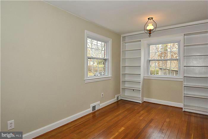 318 Whitestone Road Silver Spring, MD 20901 - Photo 7 of 28 an empty room with wooden floor closet and windows
