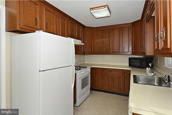 318 Whitestone Road Silver Spring, MD 20901 - Photo 8 of 28 a white refrigerator freezer sitting in a kitchen