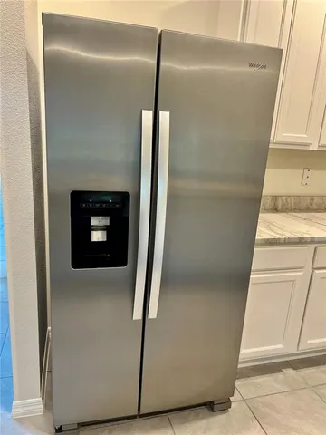 a view of room with door and a window