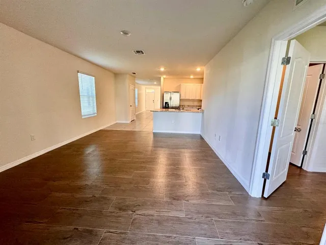 a view of a large kitchen with wooden floor and a sink