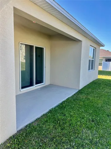 a view of an house with backyard and porch