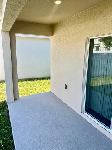 a view of an empty room with a kitchen
