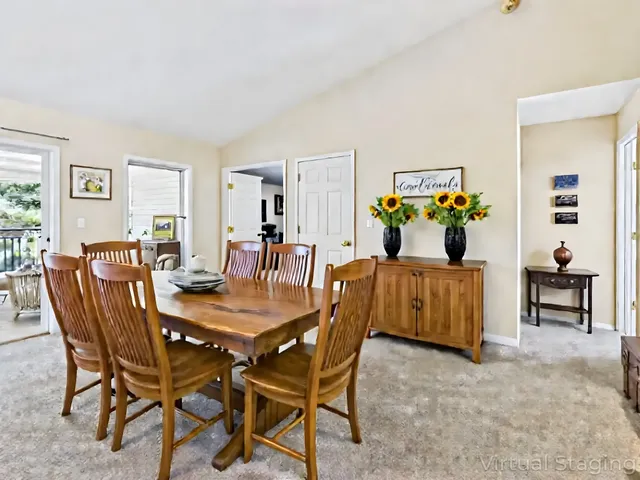 a bedroom with a large bed and paintings on the wall