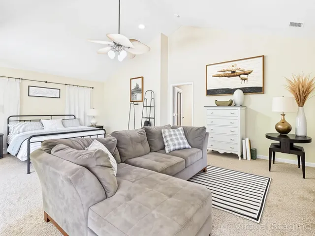 a bedroom with two beds and painting on the wall
