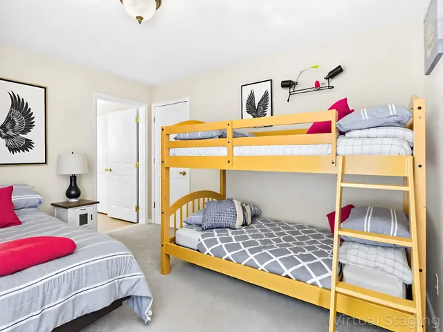 a view of a swimming pool with chairs and table in the garden