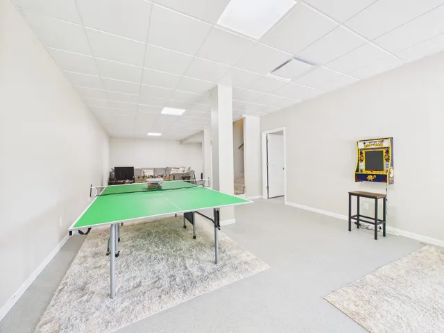 a living room with furniture kitchen view and a fireplace