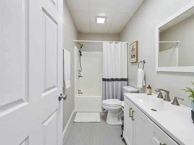 a view of a dining room and livingroom with furniture a chandelier
