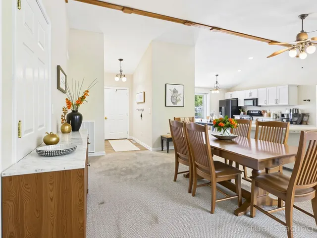 a view of kitchen with refrigerator a microwave and wooden floor