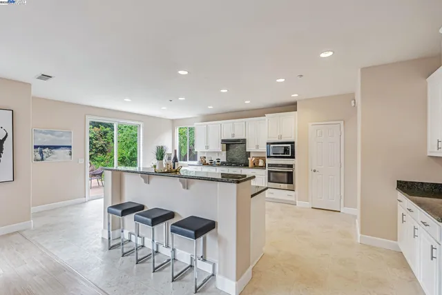a kitchen with stainless steel appliances granite countertop a sink and cabinets