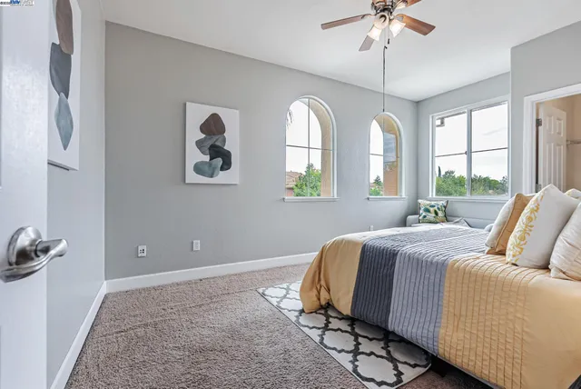 a bedroom with a bed and window