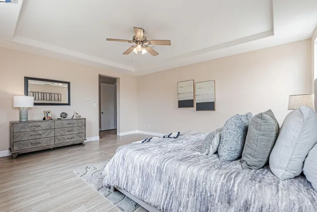 a bathroom with a granite countertop sink mirror and refrigerator
