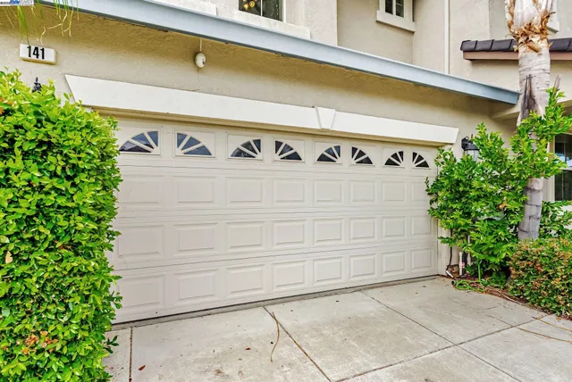 a living room with fireplace furniture and a large window