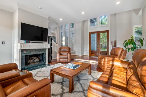 a living room with furniture fireplace and flat screen tv