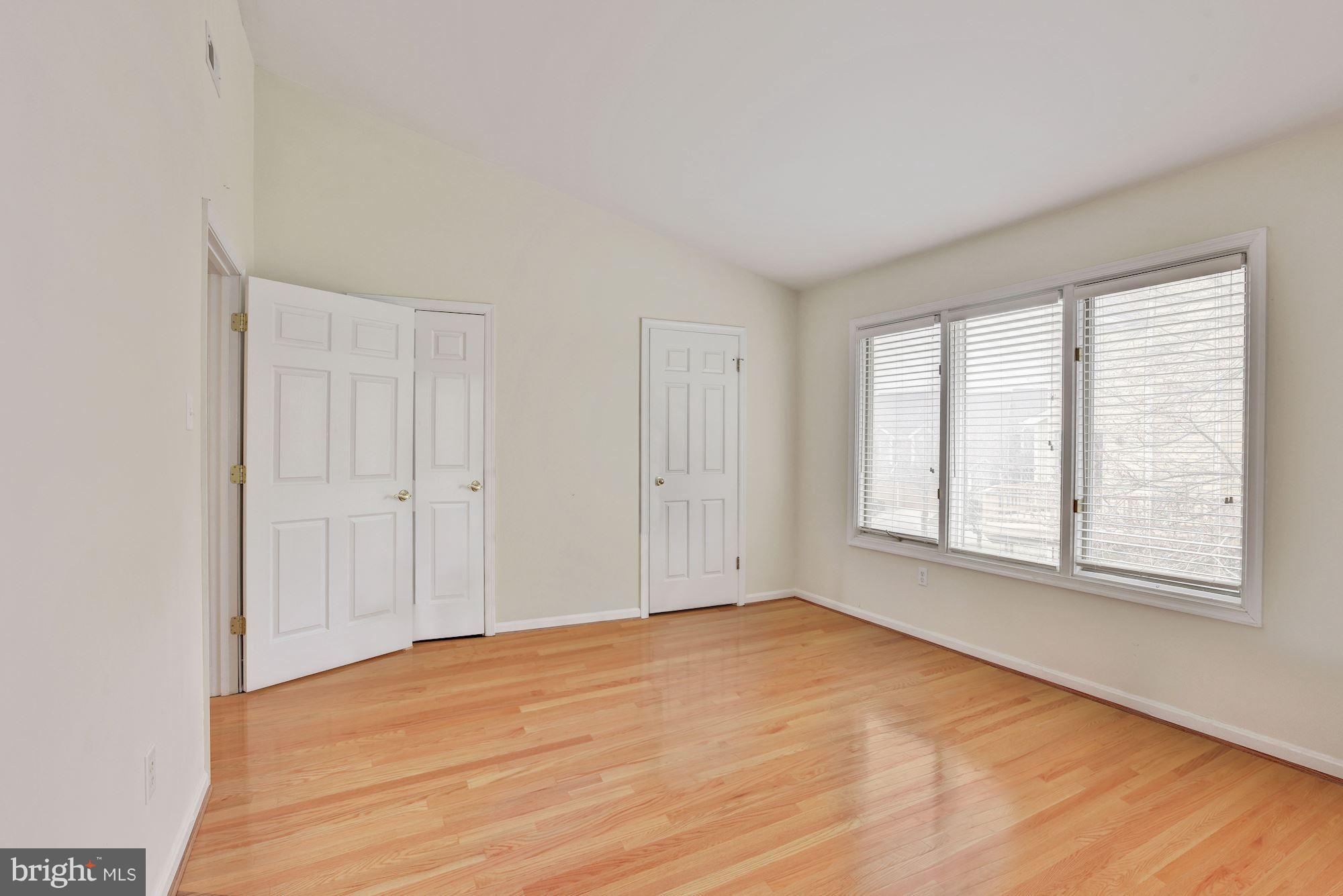 5133 Columbia Road, Unit 1595 Columbia, MD 21044 - Photo 12 of 30 a view of an empty room with wooden floor and a window