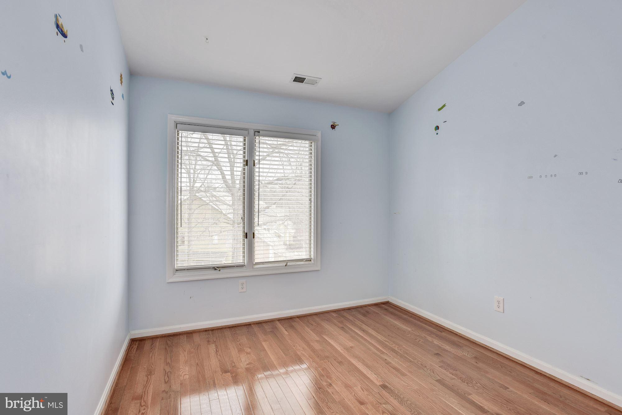 5133 Columbia Road, Unit 1595 Columbia, MD 21044 - Photo 16 of 30 an empty room with wooden floor and windows