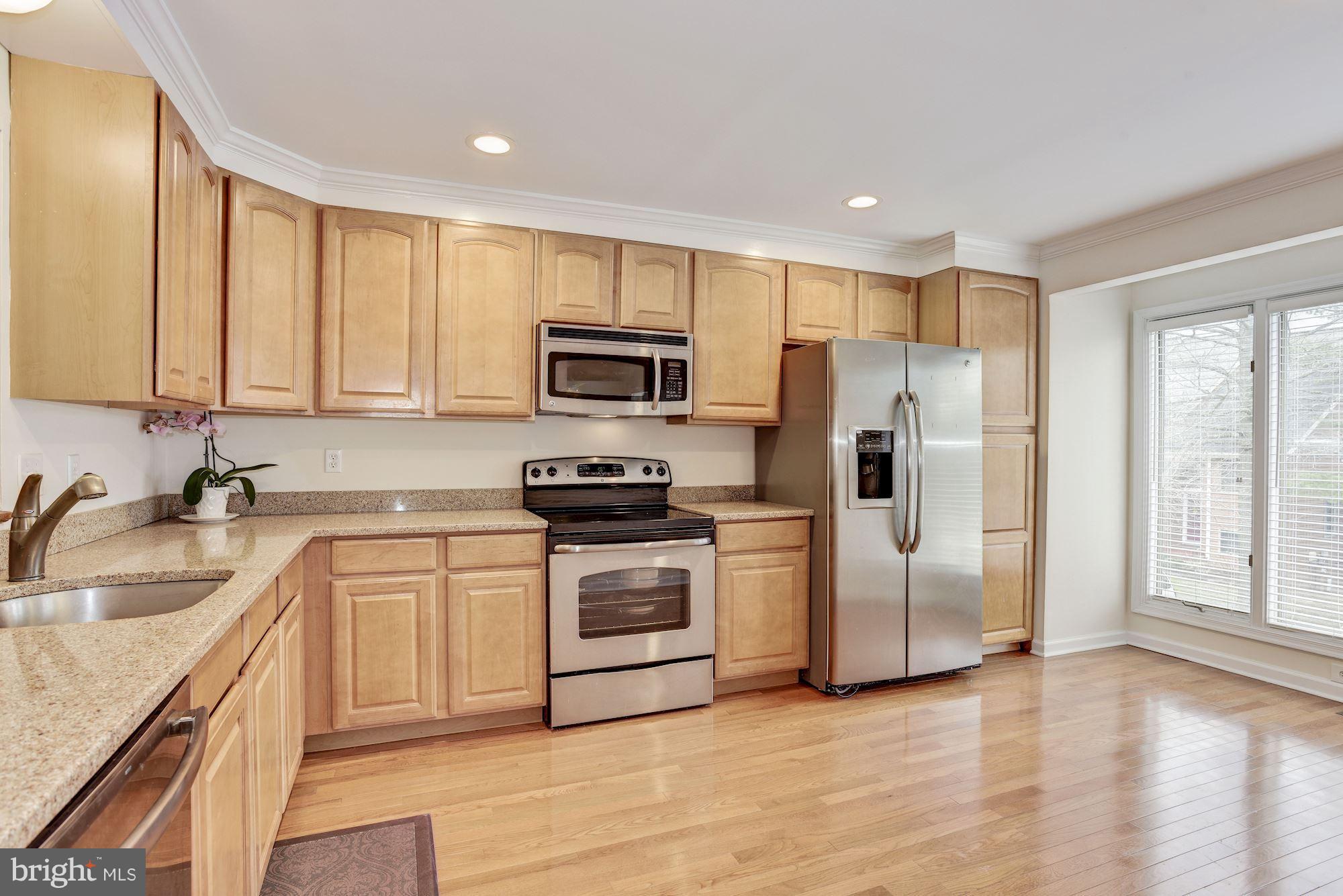 5133 Columbia Road, Unit 1595 Columbia, MD 21044 - Photo 3 of 30 a kitchen with stainless steel appliances granite countertop a refrigerator stove and sink