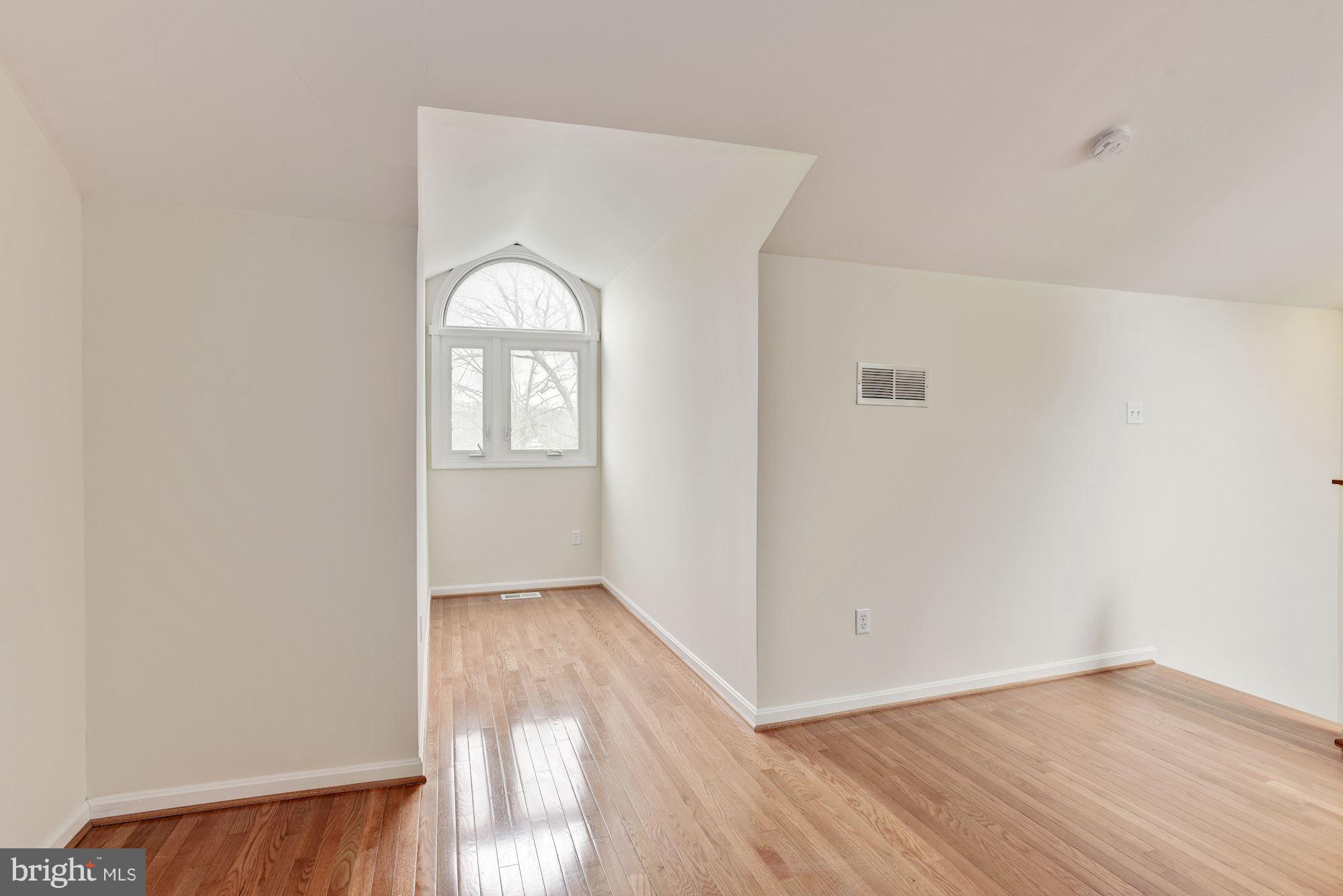 5133 Columbia Road, Unit 1595 Columbia, MD 21044 - Photo 23 of 30 an empty room with wooden floor and windows