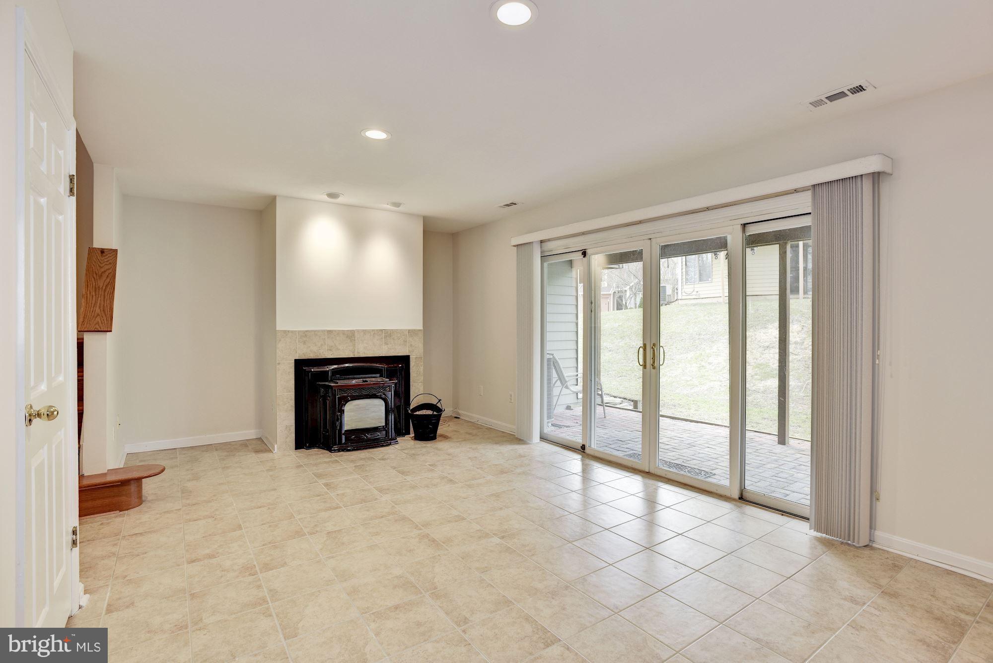 5133 Columbia Road, Unit 1595 Columbia, MD 21044 - Photo 25 of 30 a view of an empty room with a fireplace and a window