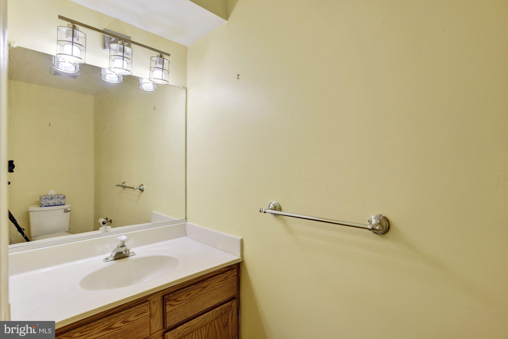 5133 Columbia Road, Unit 1595 Columbia, MD 21044 - Photo 27 of 30 a bathroom with a sink and mirror